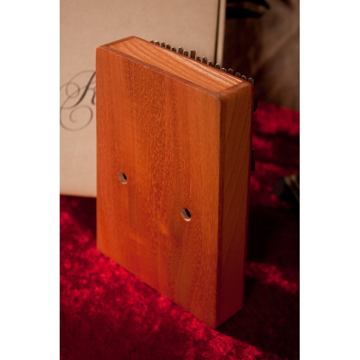 Back of the Roosebeck red cedar kalimba showing the vibrato holes
